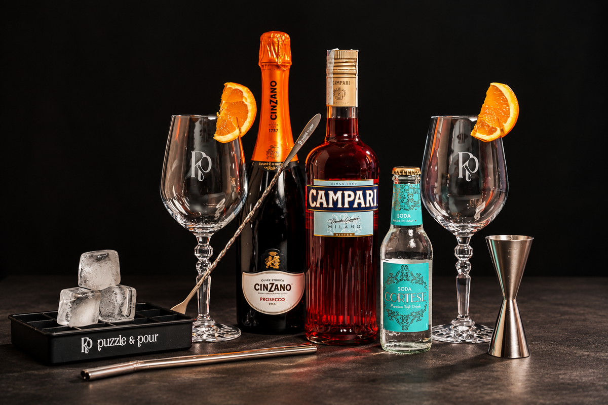 Box Campari Spritz Puzzle & Pour con Campari, Prosecco Cinzano, soda Cortese, bicchieri e accessori da cocktail. Kit completo per preparare a casa un autentico Campari Spritz, perfetto come idea regalo per chi ama aperitivi italiani, cocktail e mixology.